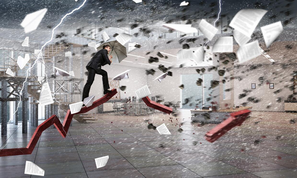 man walking in a storm with an umbrella